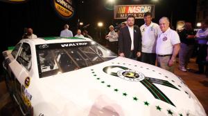 DAYTONA BEACH, FL - FEBRUARY 14: (L-R) Owner of Swan Racing Brandon Davis, Michael Waltrip, and Sandy Hook Fire Chief Bill Halstead pose for a photo at the unveiling of the #26 car to benefit victims of the Newtown, CT shooting at the 2013 NASCAR media day at Daytona International Speedway on February 14, 2013 in Daytona Beach, Florida. (Photo by Jonathan Ferrey/Getty Images)